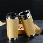 Two bamboo-wrapped stainless steel travel mugs with lids.