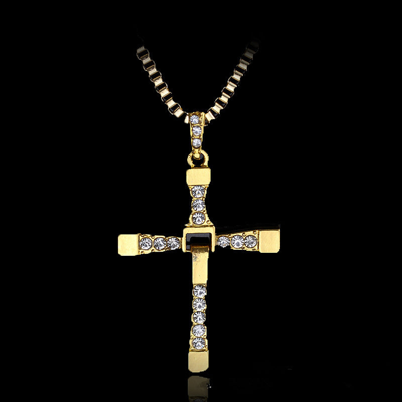 Gold inverted cross pendant with clear rhinestones on chain.
