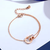 Rose gold bracelet with interlocking rings and Roman numerals.