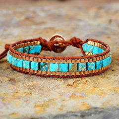 Turquoise jasper and copper beads woven on brown leather cuff.