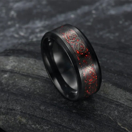 Black ring with red sparkle and dragon design.