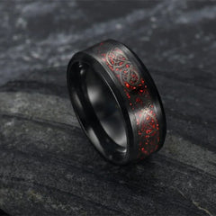 Black ring with red sparkle and dragon design.