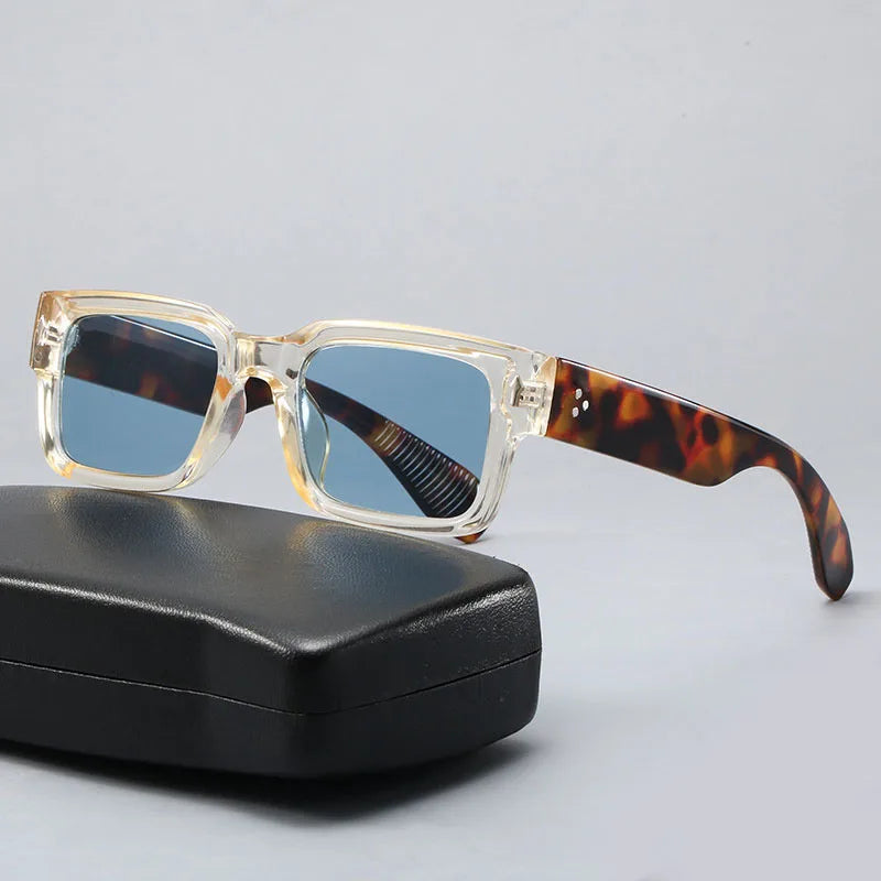 Thick, clear square sunglasses with blue lenses and tortoiseshell arms resting on a black case.