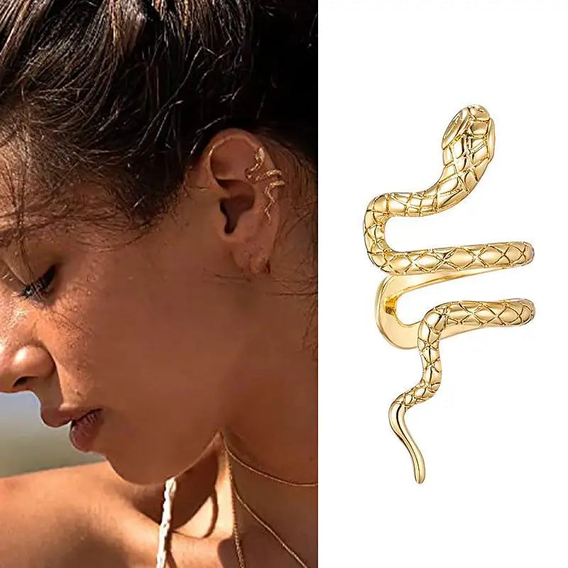 Gold textured coiled snake ear cuff worn by a woman.
