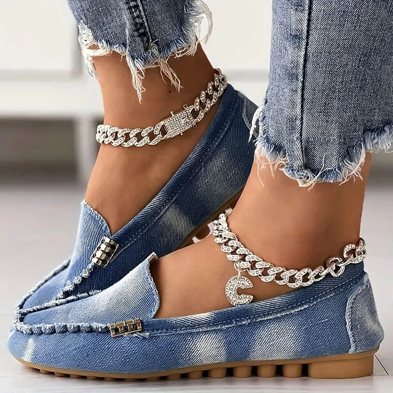 Faded blue denim loafers and jeans with rhinestone anklets.