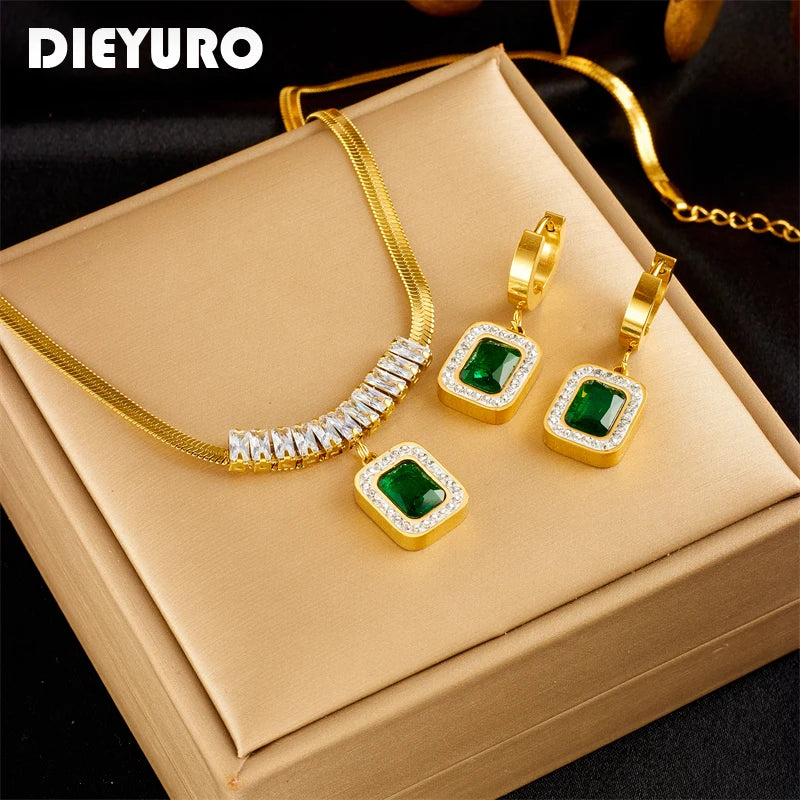 Gold snake chain necklace and earring set with green stones.