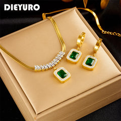 Gold snake chain necklace and earring set with green stones.