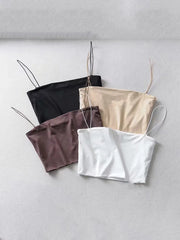 Four spaghetti strap cami crop tops in black, tan, brown, and white.