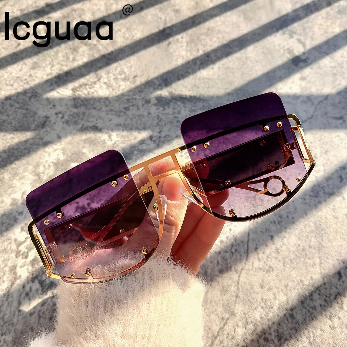 Oversized gold-framed rimless sunglasses with purple gradient lenses.