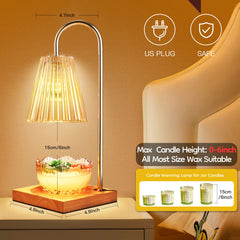 A gold and wood electric candle warmer lamp with an amber glass shade over a bowl of wax.