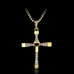 Gold inverted cross pendant with clear rhinestones on chain.