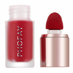 A frosted glass bottle of red liquid blush with a red applicator wand next to it.