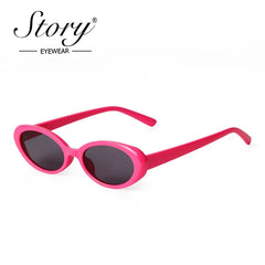 A single pair of pink oval-frame sunglasses with dark lenses on a white background.