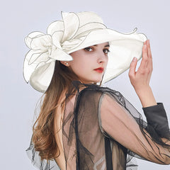 Jarreims Emporium: Woman in white floppy hat with sheer flower.