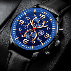 A men's chronograph watch with a blue face, gold accents, and a black leather strap.