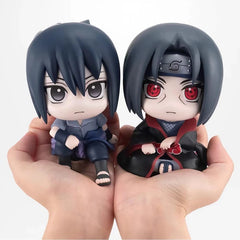 Chibi-style figures of Sasuke and Itachi Uchiha from Naruto.