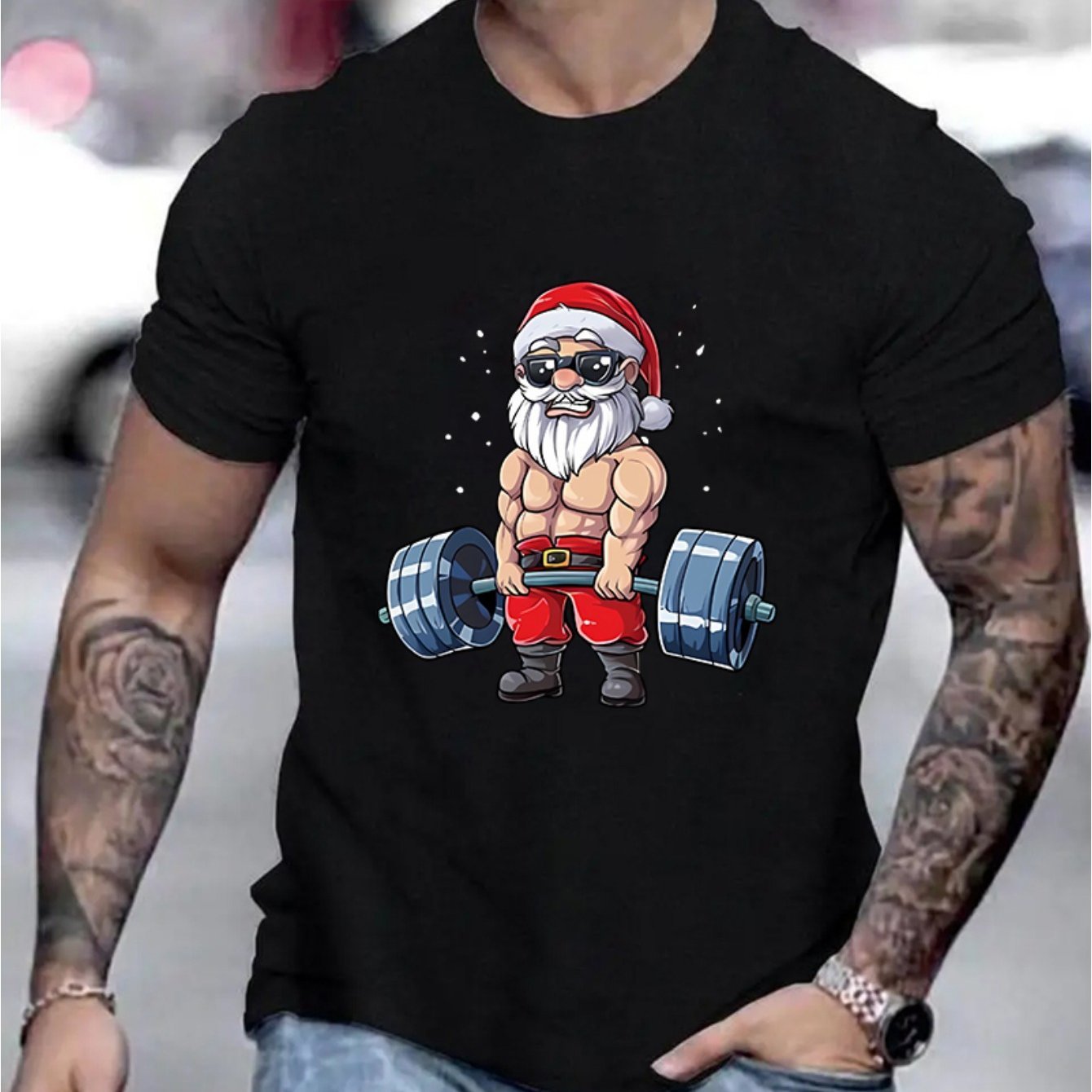 Jarreims Emporium: Muscular Santa lifting barbell on black shirt.